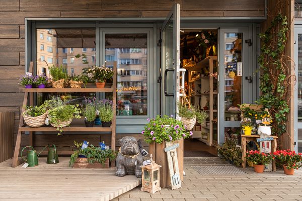 Homy floral shop with shelves of flowers and garden decorations